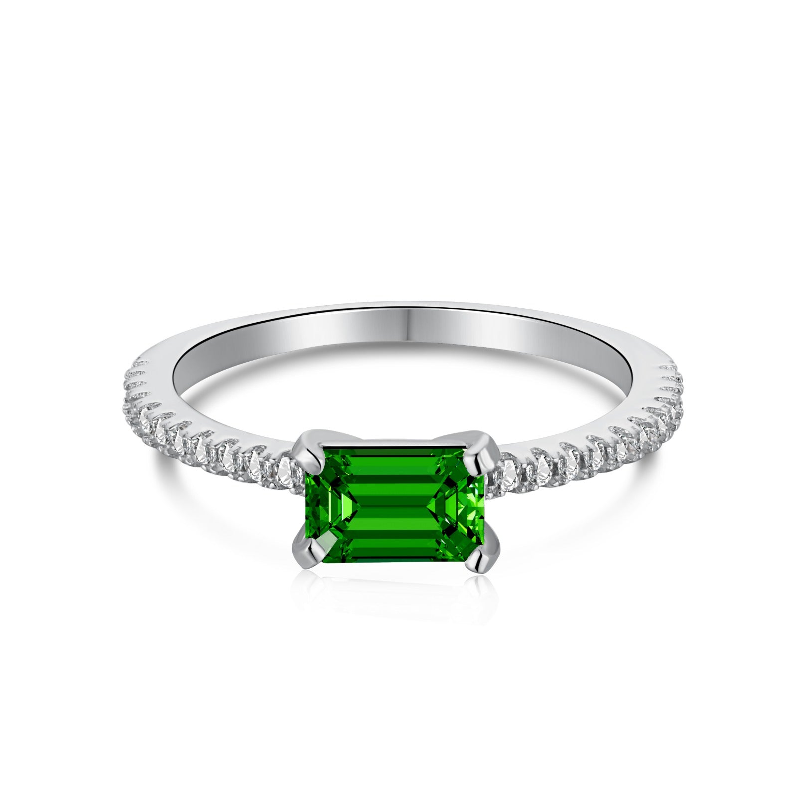 A silver ring featuring a rectangular emerald cut main stone with a surrounding diamond-accented band.