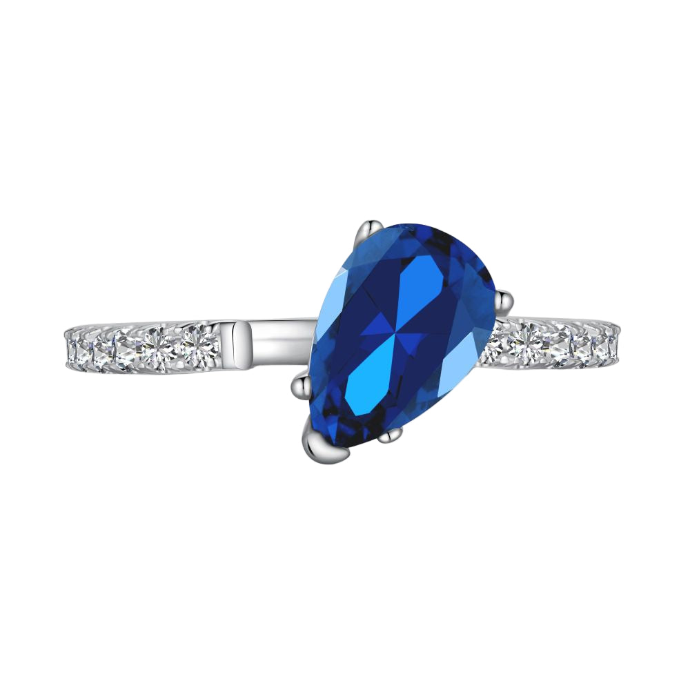 A blue pear-shaped zircon ring with a white silver band and small clear crystals set around the top edge.