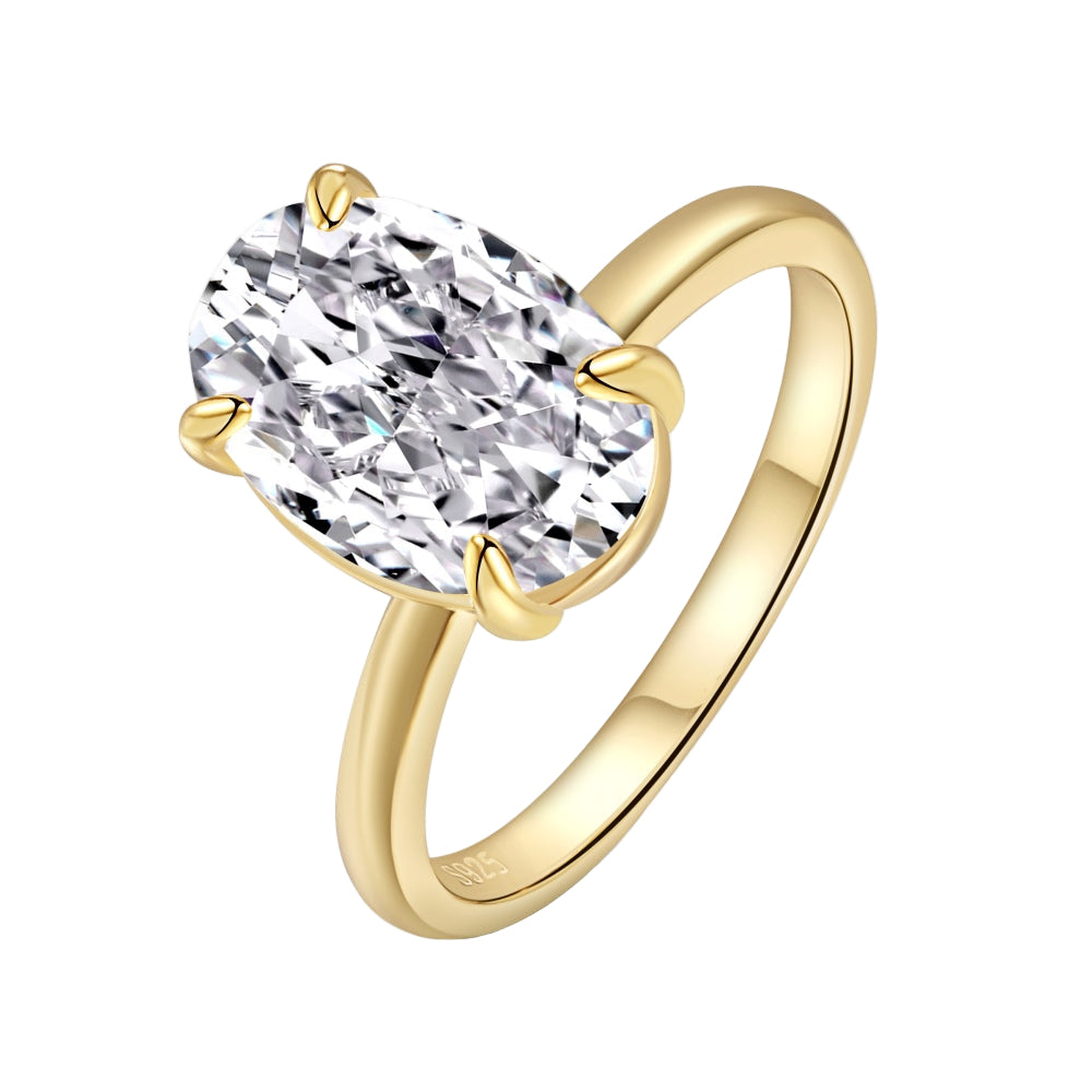 A gold-colored band solitaire ring with a large oval-shaped clear stone