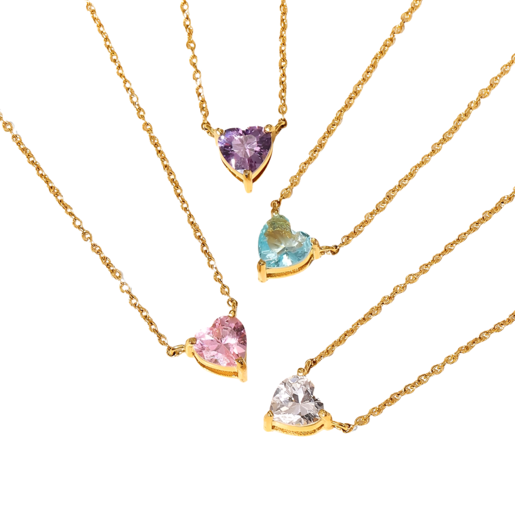 A collection of heart-shaped necklaces in gold color with different colored gemstones.