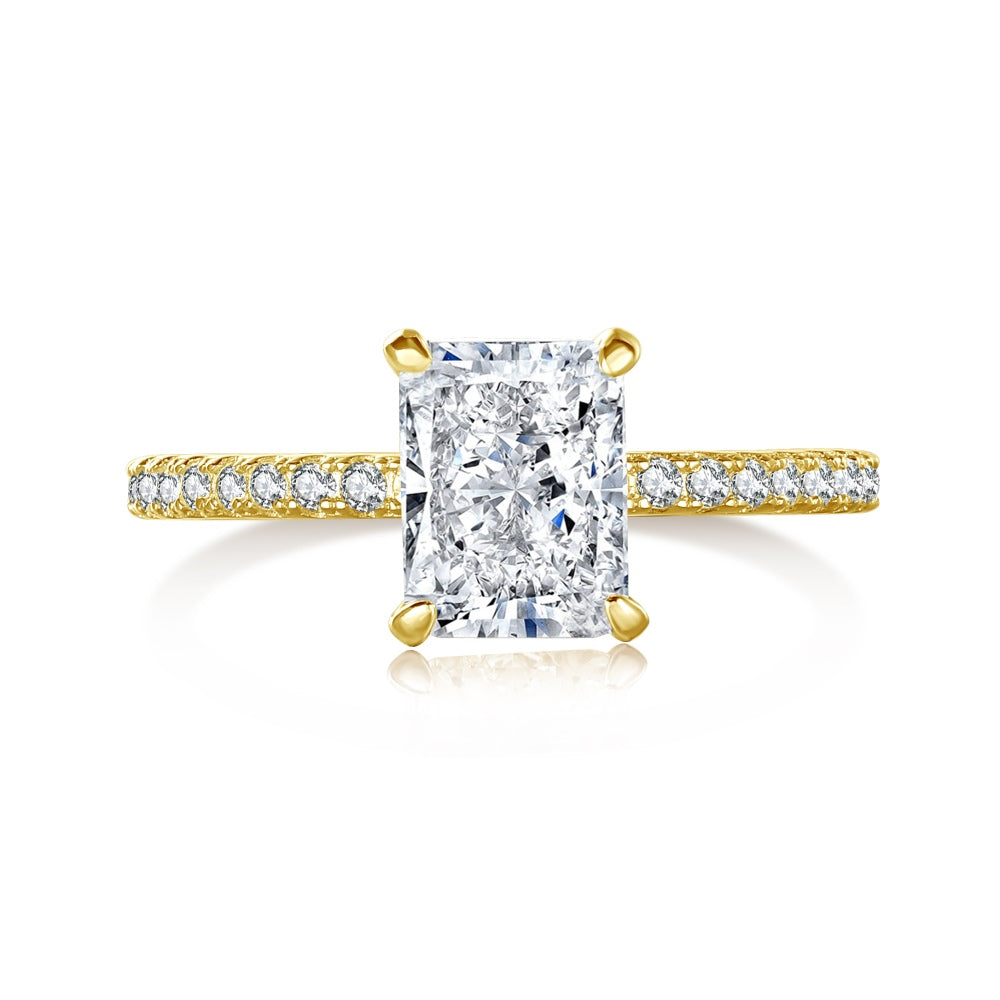 A rectangular radiant cut central diamond with smaller stones set in a gold band