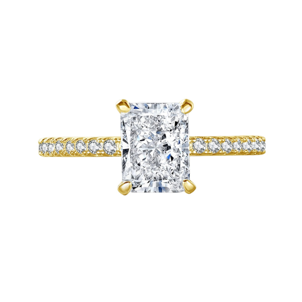 A rectangular radiant cut central diamond with smaller stones set in a gold band