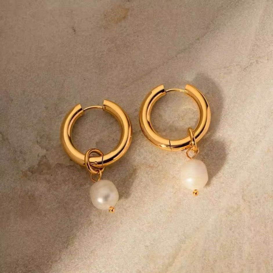 A pair of 18k gold plated stainless steel huggie earrings with freshwater pearl pendant.