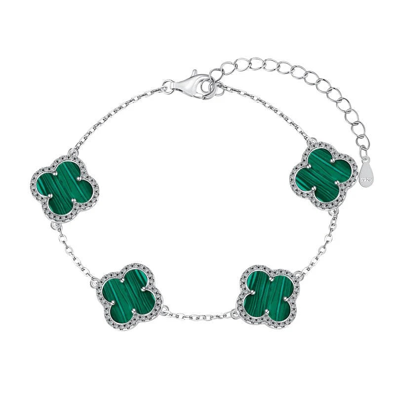 A sterling silver necklace with a clover-shaped pendant adorned with green shell.