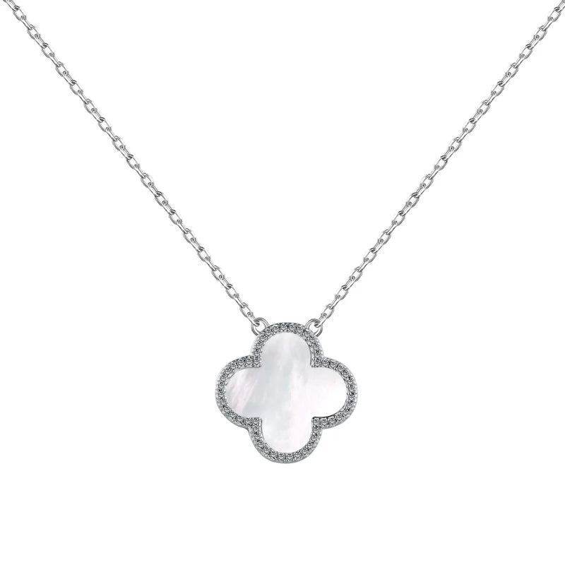 A silver necklace featuring a clover design with clear shell accents on a chain.