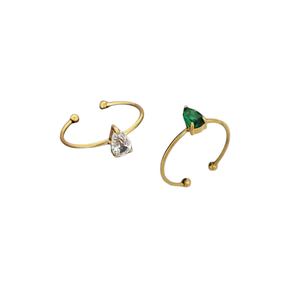 Gold rings with diamond and emerald on a white background