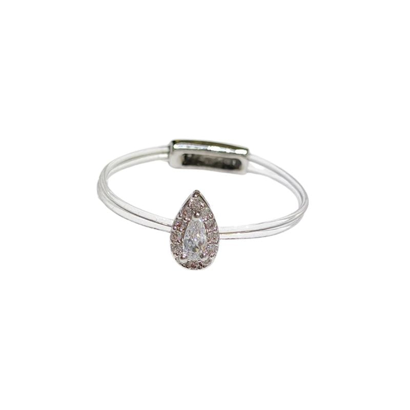Pear-shaped diamond ring on a clear stand with a white background