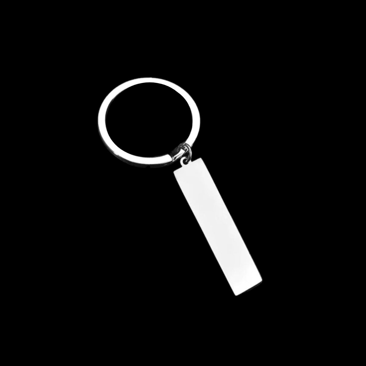 A silver stainless steel keyring with a customizable engraved tag, displayed against a black background.