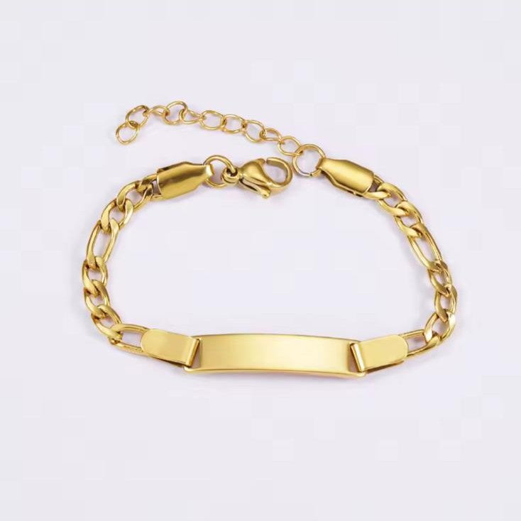 Gold bracelet with an engravable nameplate on a white background
