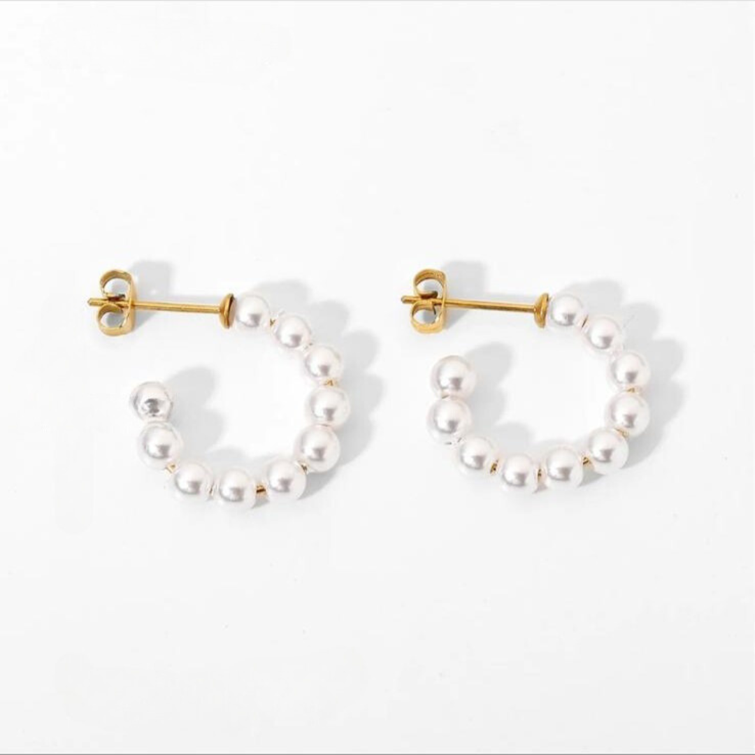 A pair of pearl hoop earrings with a stainless steel C-shape design, displayed in white color.