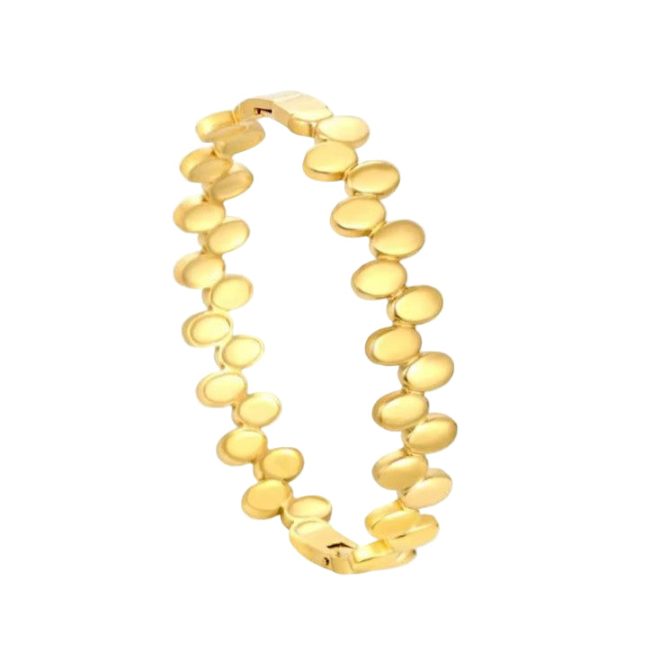 Classic gold polka dotted bracelet on a white background