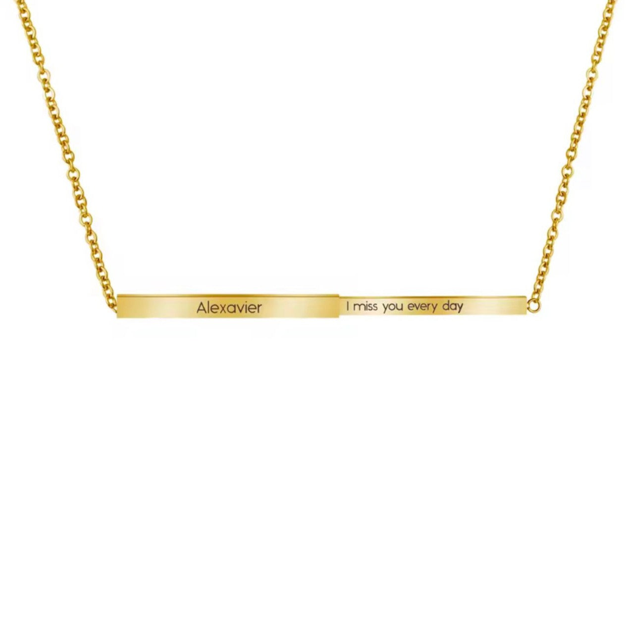 Gold necklace with engraved message on a bar pendant on a white background