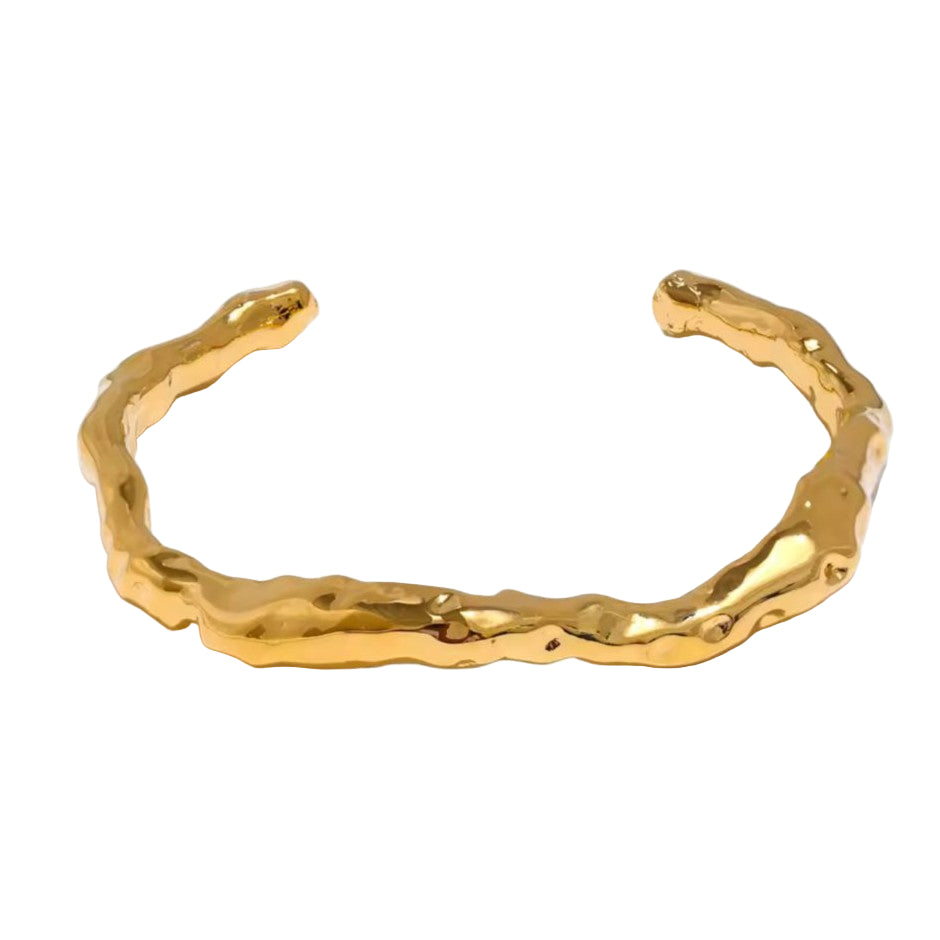 Gold Hammered bracelet on a white background