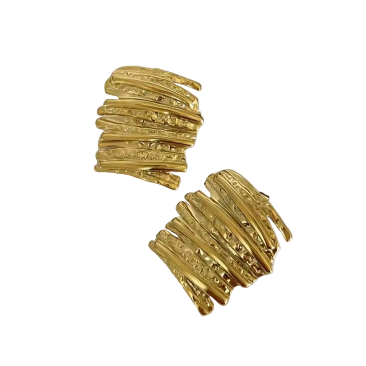 Gold textured abstract earrings on a white surface