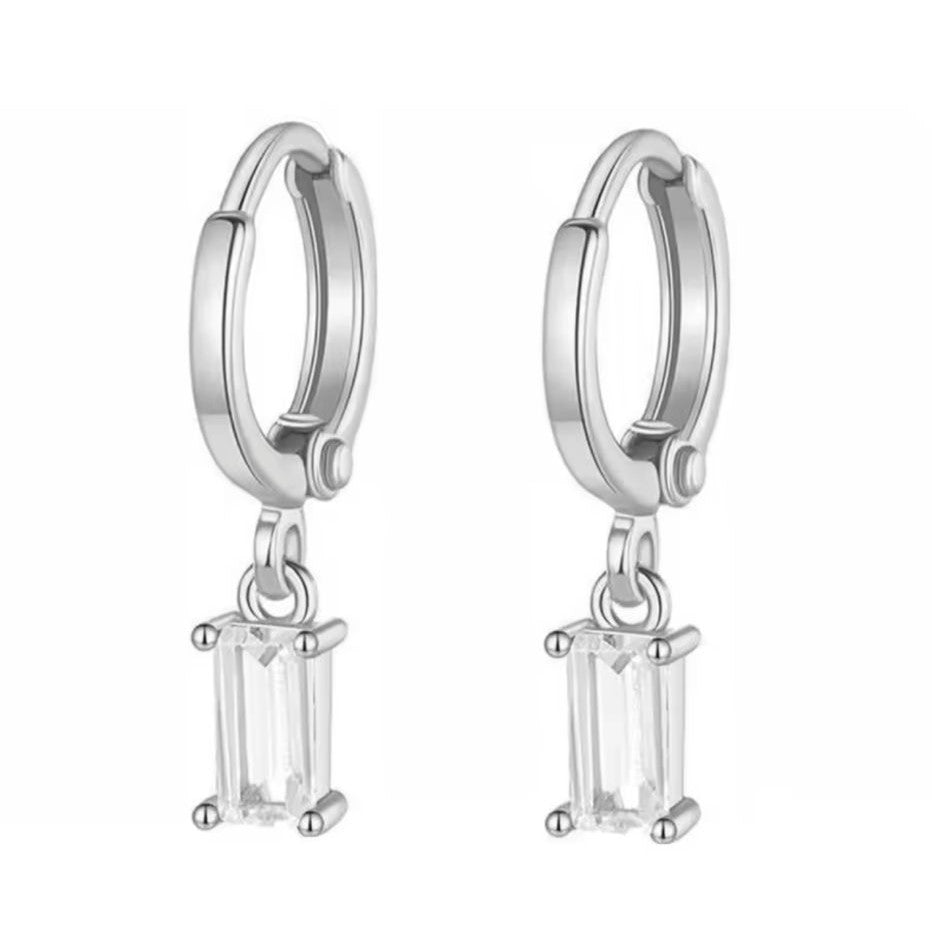 A pair of gold-colored stainless steel hoop earrings with a simple geometric drop design.