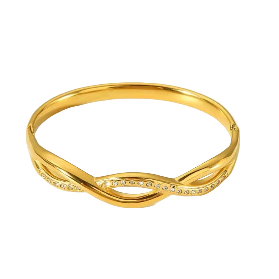 A gold-colored stainless steel bangle bracelet with an infinity symbol design, featuring sparkling accents on the loops.