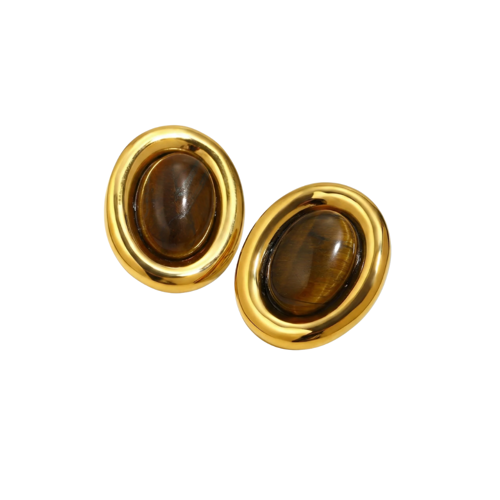 Pair of gold earrings with large natural stones on a white background