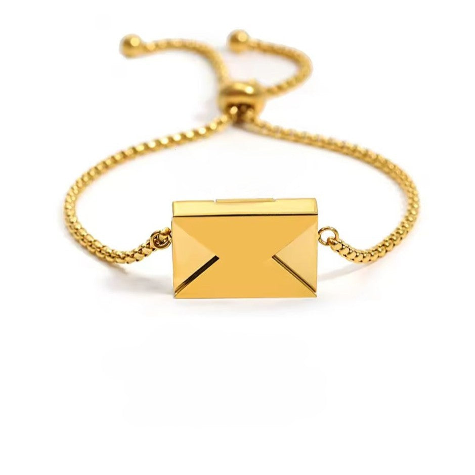Gold bracelet with "Love you" engraved envelope on a white background