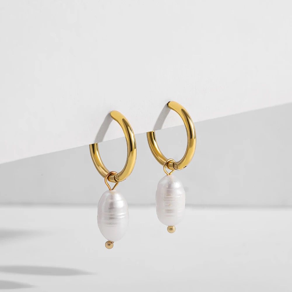 A pair of gold-colored stainless steel pearl drop earrings with a minimalist design.