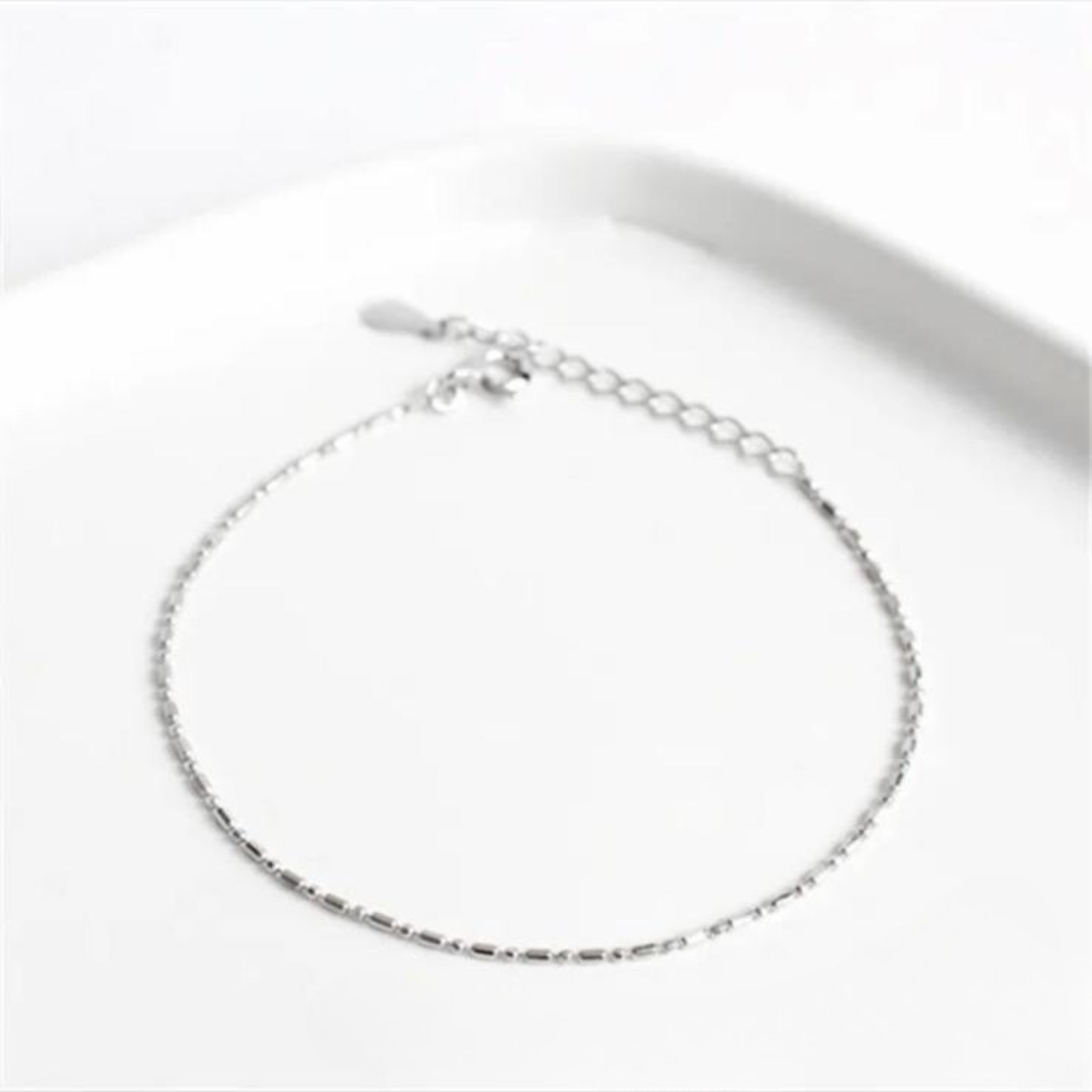 A silver-colored sterling silver chain bracelet with a box clasp closure, presented against a white background.