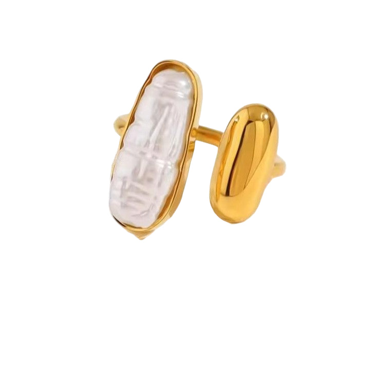 Gold ring with a white pearl-like center on a white background