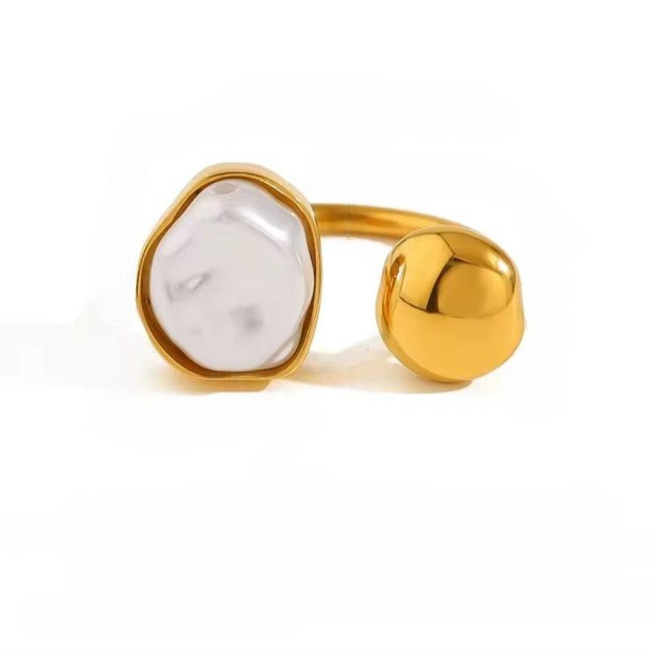 Gold ring with a white stone on a white background