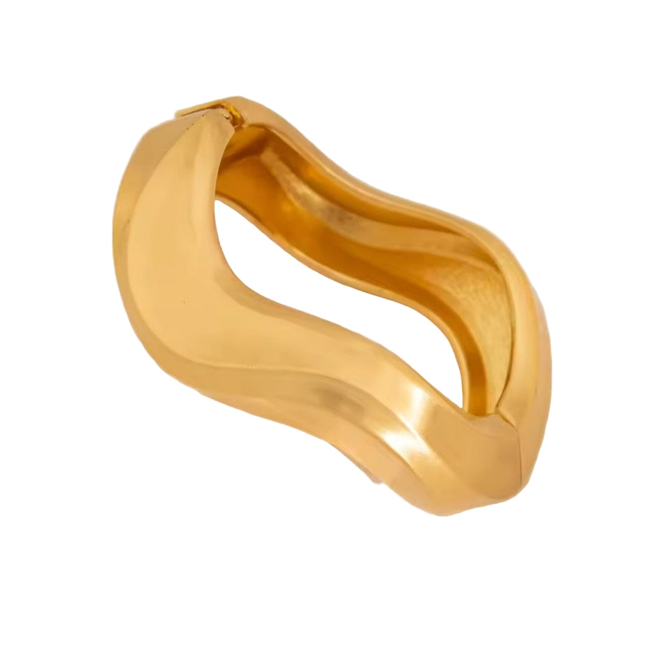 Gold Bangle on a white fabric background