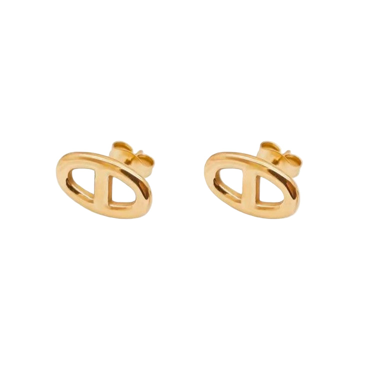 Gold earrings on a light beige background