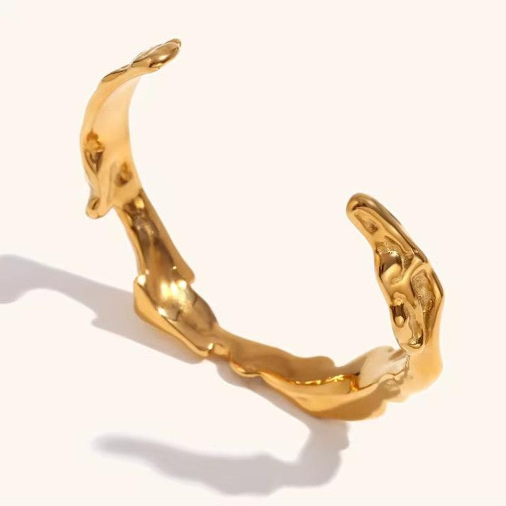 Wrinkle Gold bracelet on a plain background