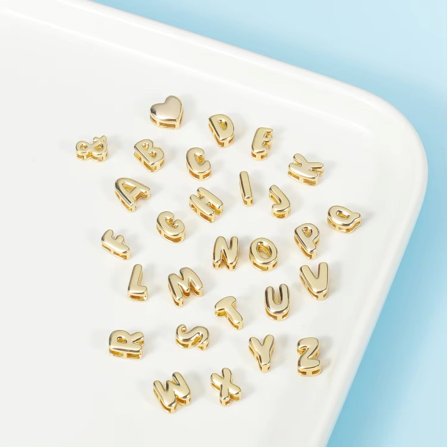 A gold bubble charm spellings for your personalized necklace.