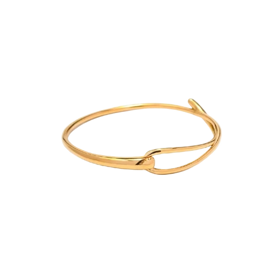 A gold-colored bangle/bracelet with a intertwined design on a white background.