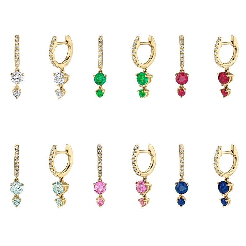 A collection of Sienna Huggie Hoop Drop Earrings in various colors including blue, green, red, pink, and multicolored gemstones, all in gold-tone settings.