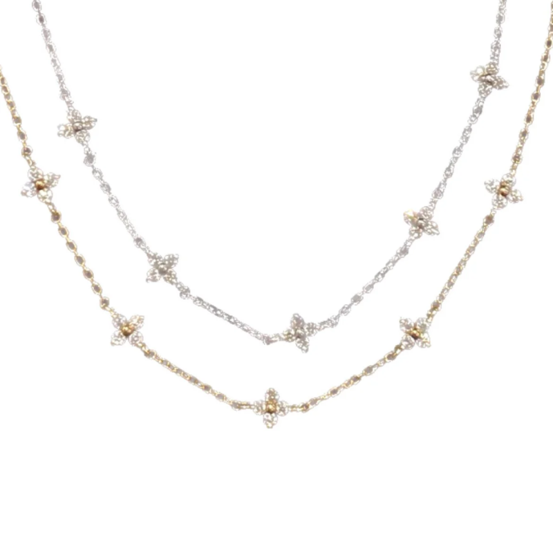 Two small dainty flower bracelets with chains in gold and silver color, featuring multiple small flowers as pendants.