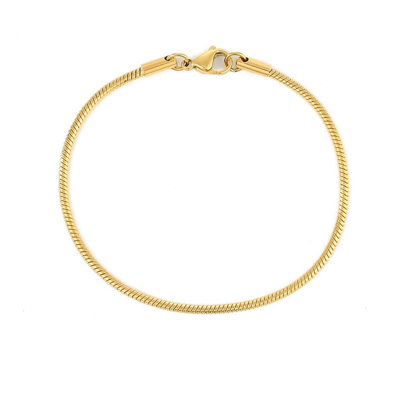A gold-colored snake chain bracelet with a lobster clasp.