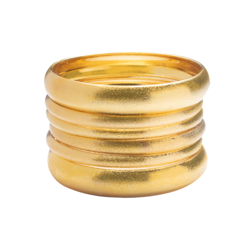 A set of six textured gold bangles displayed on a white background.