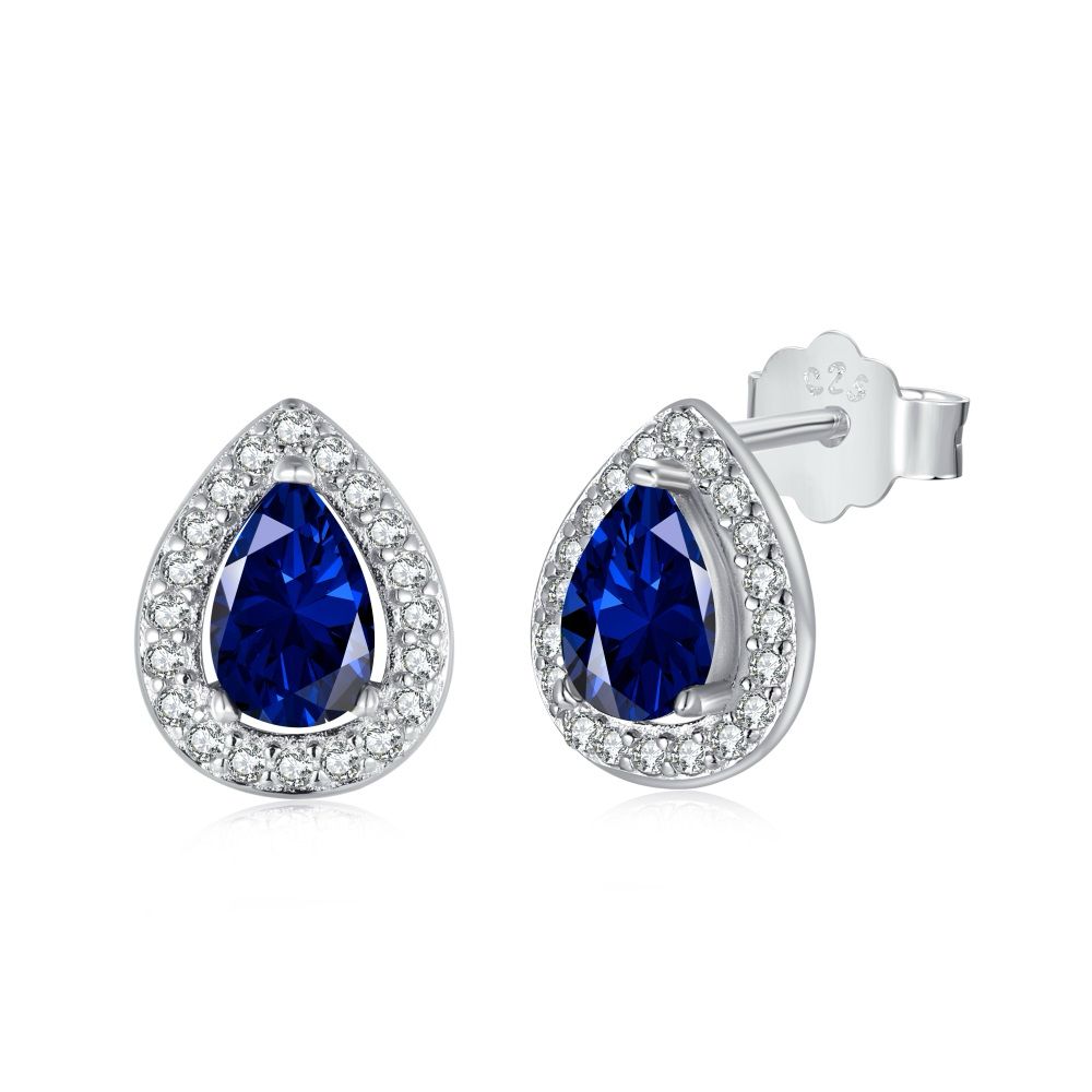 A pair of pear-shaped stud earrings with blue main stones and clear accent stones set in sterling silver bands.