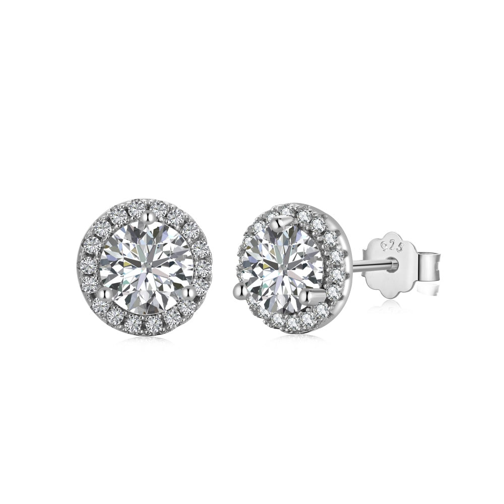 A pair of rhodium-plated stud earrings with a clear, zirconia main stone set in a small circle design.