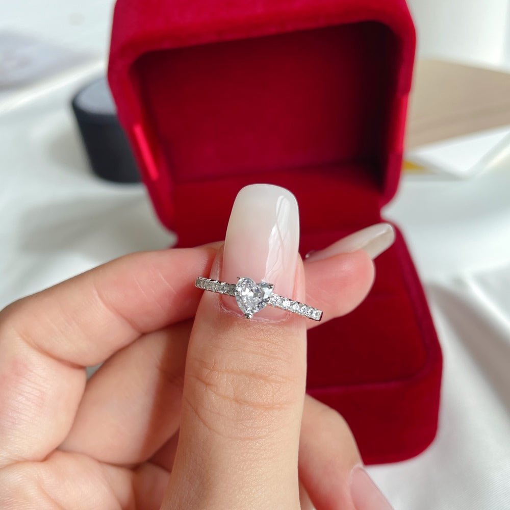 A heart-shaped ring with a main stone size of 5*5mm, crafted in genuine sterling silver with a rhodium plating, featuring a heart-shaped design.