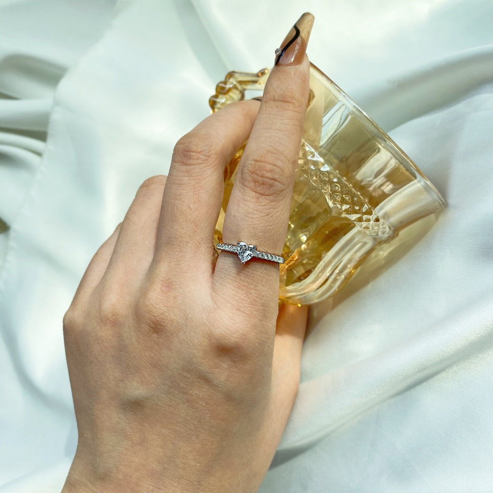 A heart-shaped ring with a main stone size of 5*5mm, crafted in genuine sterling silver with a rhodium plating, featuring a heart-shaped design.