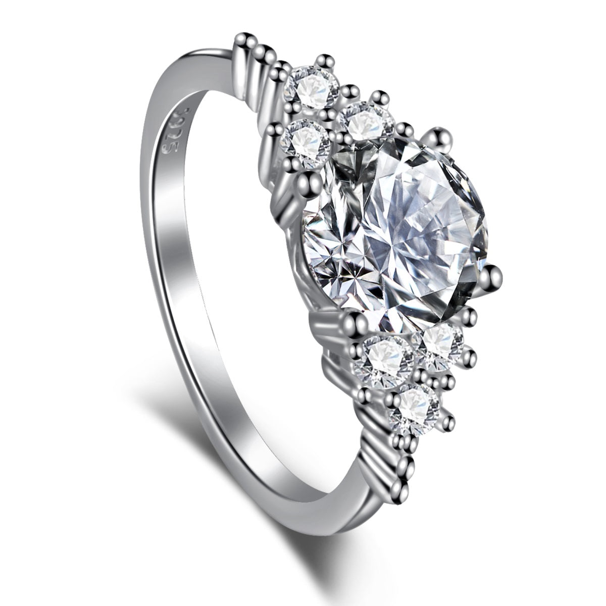 An elegant sterling silver ring with a large central clear cubic zirconia stone, surrounded by smaller clear stones, set in a silver-tone band.