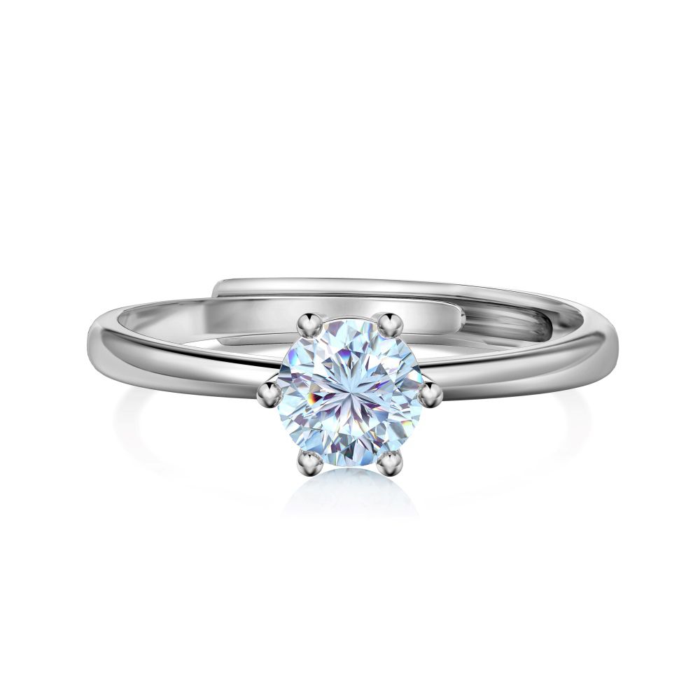 An adjustable ring with a round clear color birthstone set in a silver-colored band.