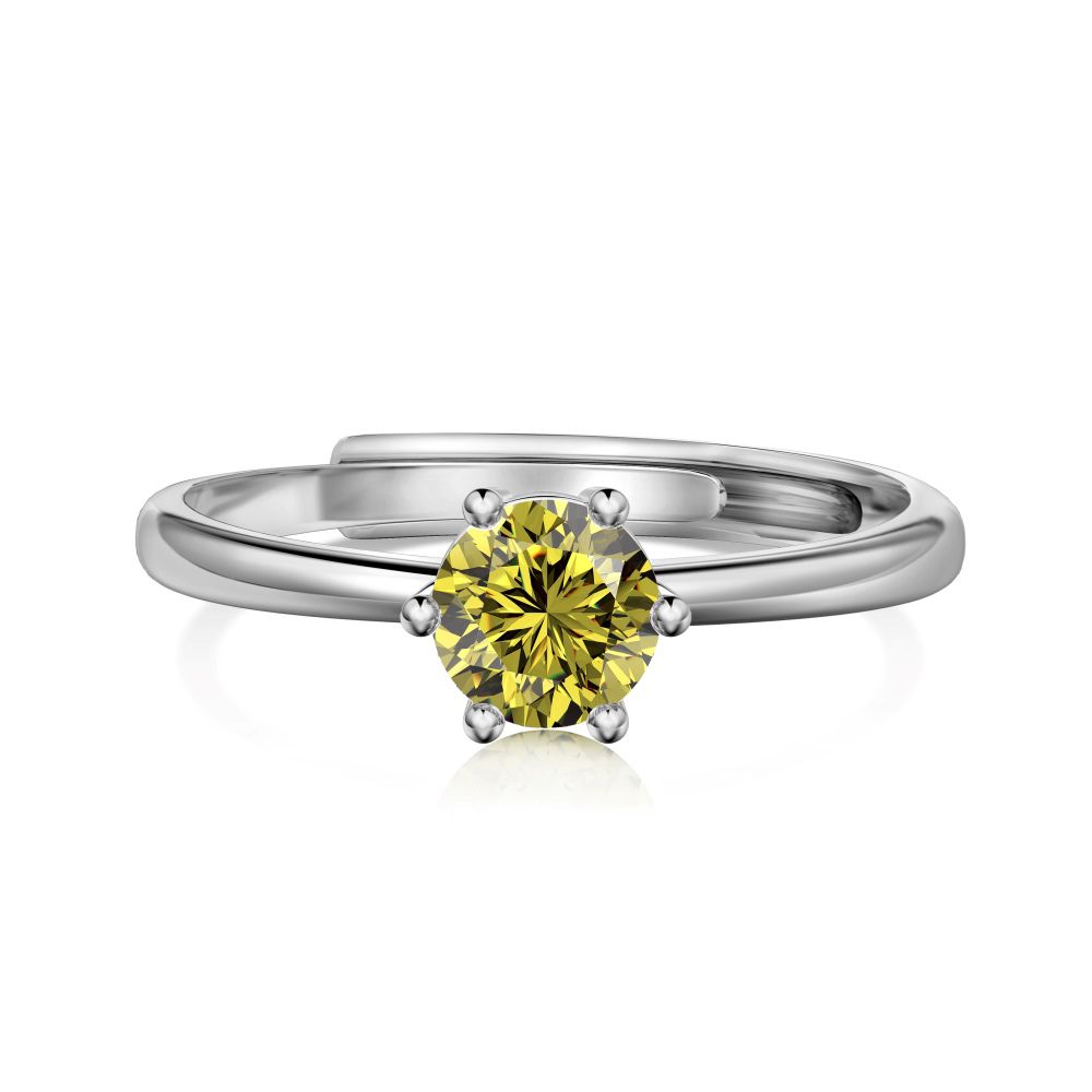 An adjustable ring with a round yellow birthstone set in a silver-colored band.