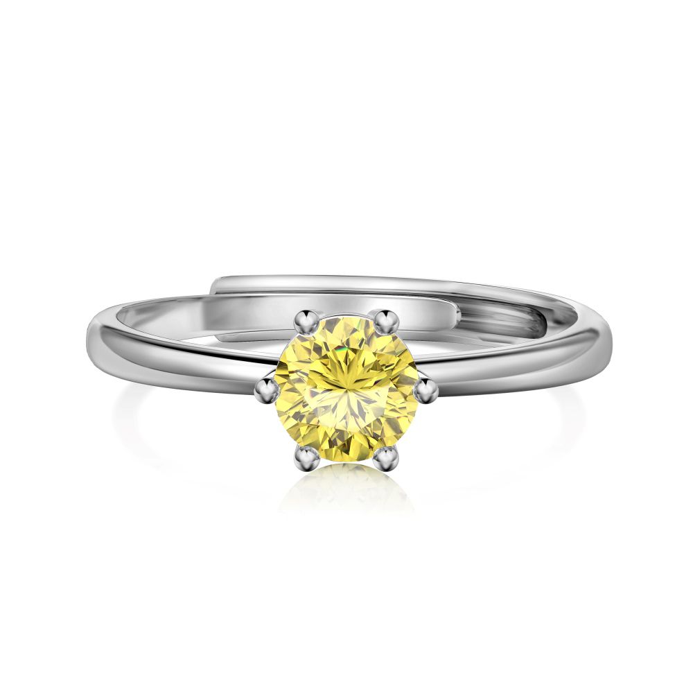 An adjustable ring with a round yellow birthstone set in a silver-colored band.