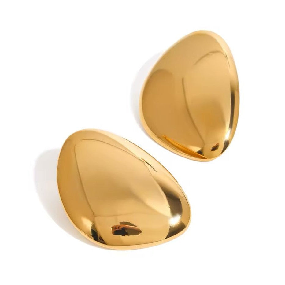 Pair of gold earrings on a white background