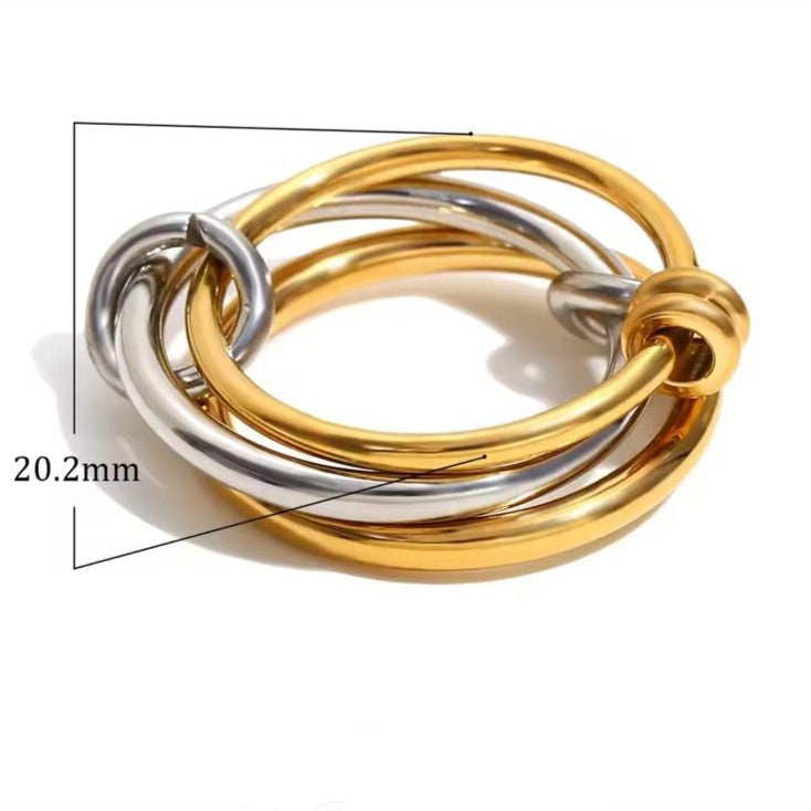 A ring with set of three interlocking rings with gold and silver colors, crafted from 18K gold plated stainless steel.