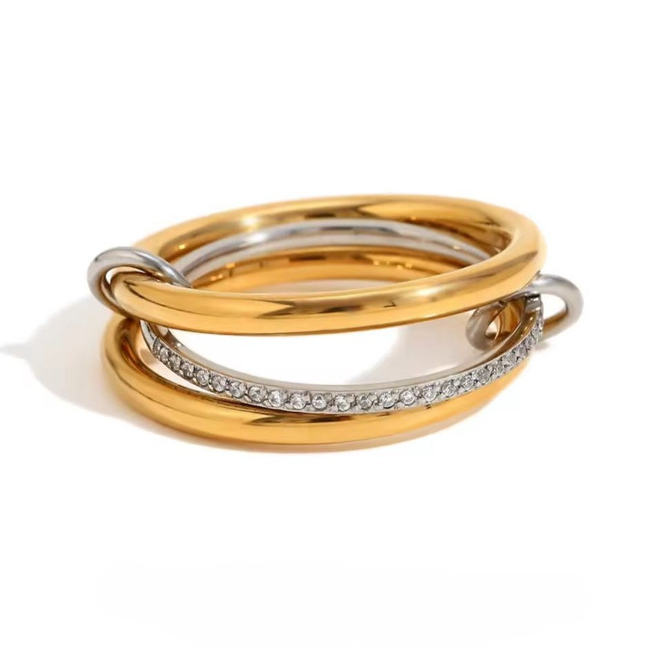 A ring with set of three interlocking rings with gold and silver colors, crafted from 18K gold plated stainless steel.