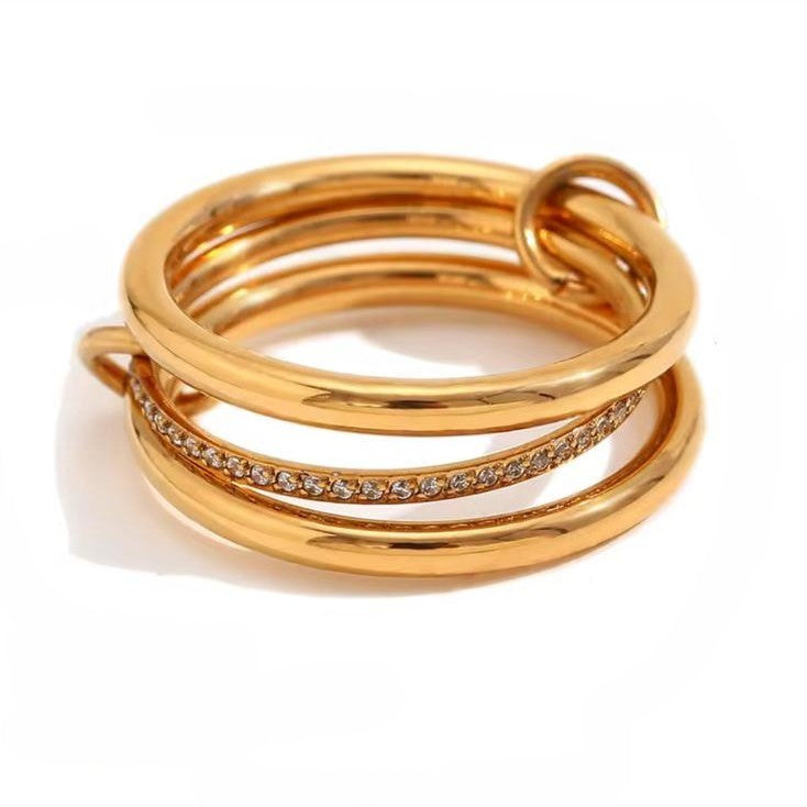A ring with set of three interlocking rings with small diamonds and gold colors, crafted from 18K gold plated stainless steel.