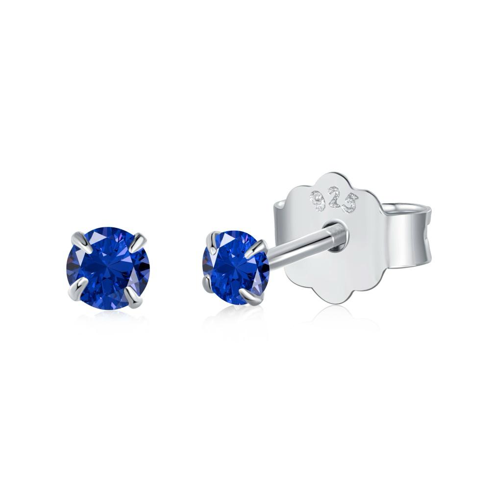 A pair of Luxe Stud Earrings with blue stones on a white background.
