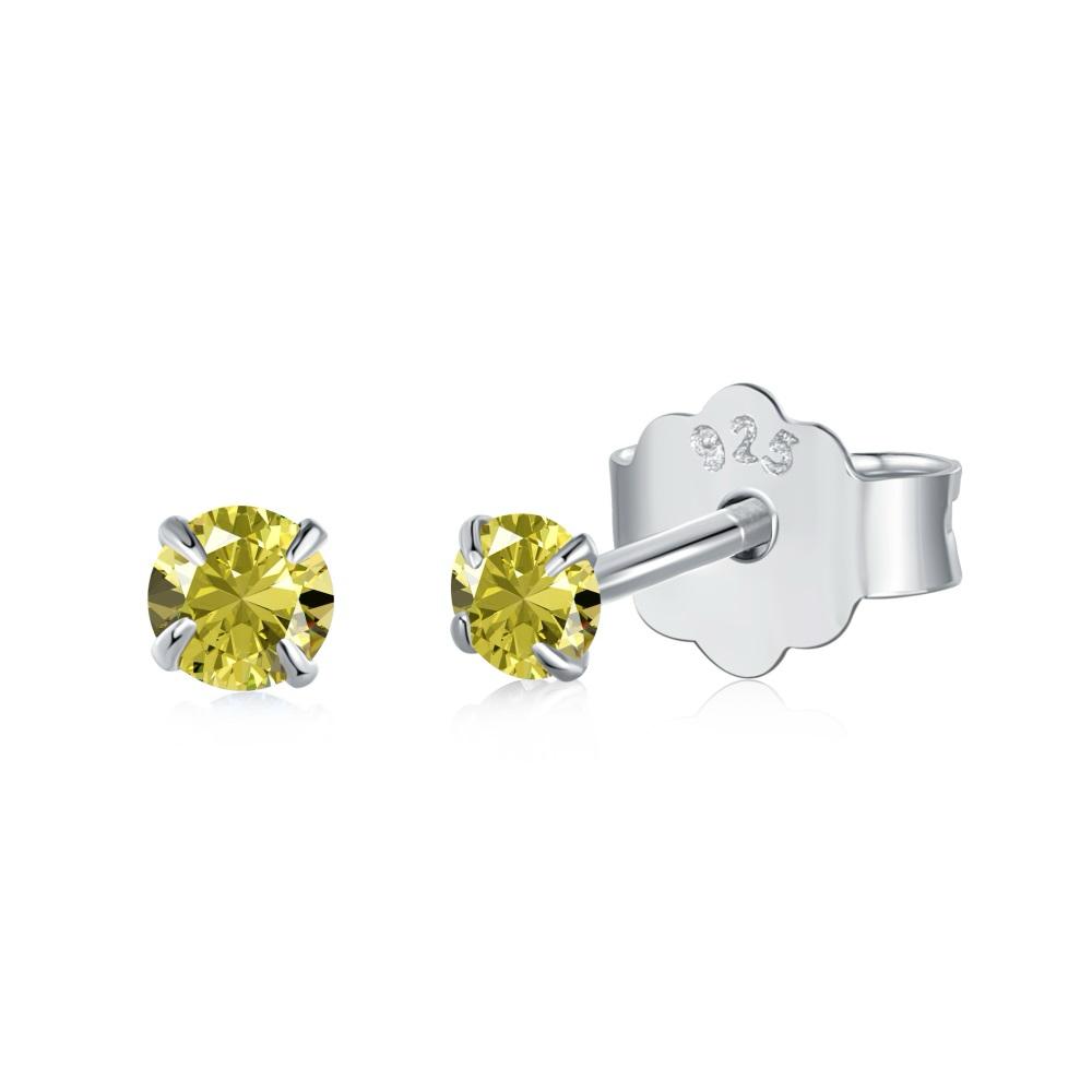 A pair of Luxe Stud Earrings with yellow stones on a white background.