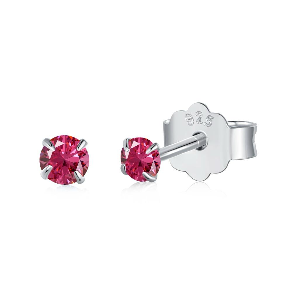 A pair of Luxe Stud Earrings with red stones on a white background.